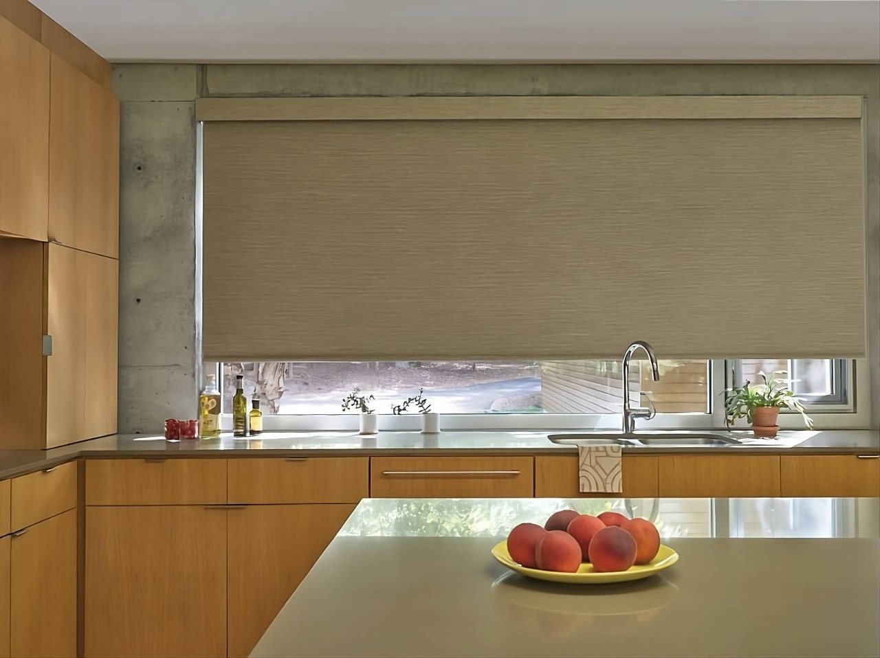 Hunter Douglas kitchen roller shades in a modern, warm-toned space with a large island at All About Blinds near Johnson City, TN