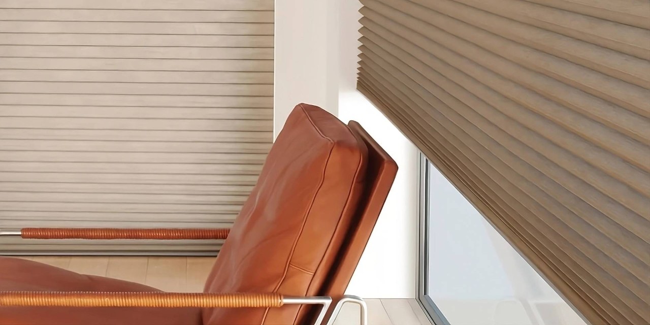 Energy-efficient shades, Hunter Douglas Duette® Cellular Shades on large windows with a leather chair in front at All About Blinds near Johnson City, TN