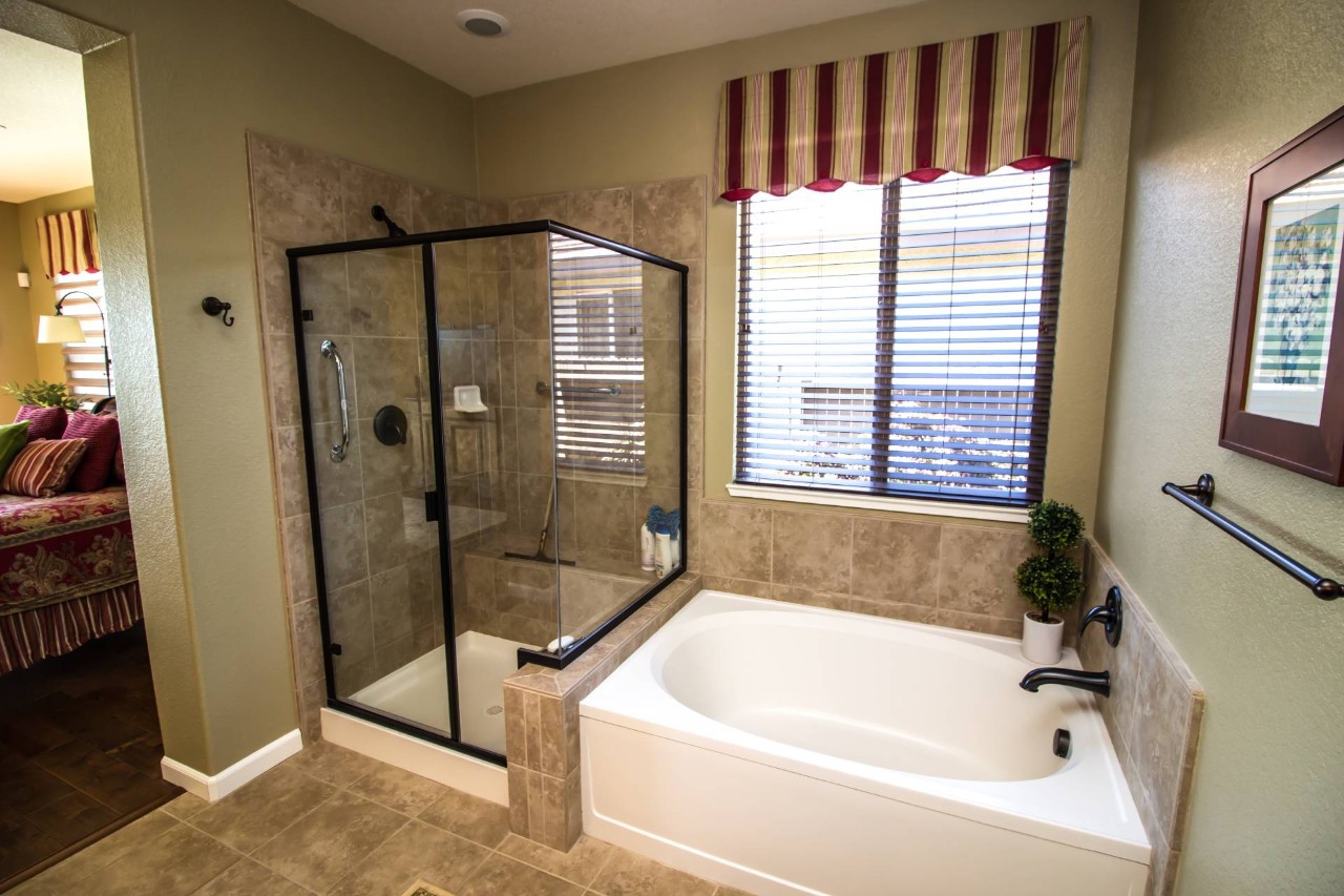 A valance on a window in a modern bathroom with a glass shower and separate tub at All About Blinds near Johnson City, TN