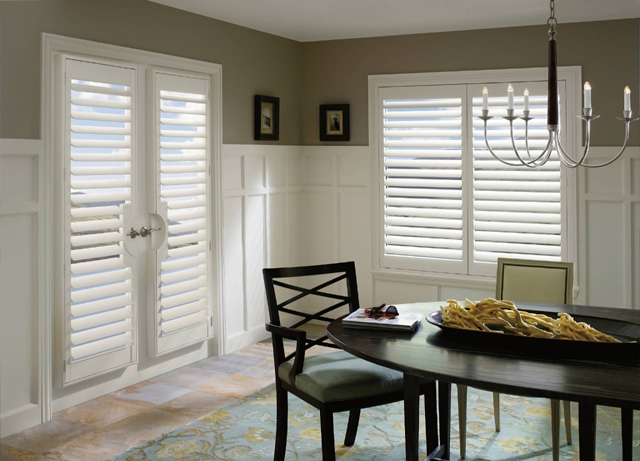 Hunter Douglas Palm Beach™ Polysatin™ Vinyl Shutters as French door shutters in a traditional dining room at All About Blinds JC near johnson city, Tennessee (TN)
