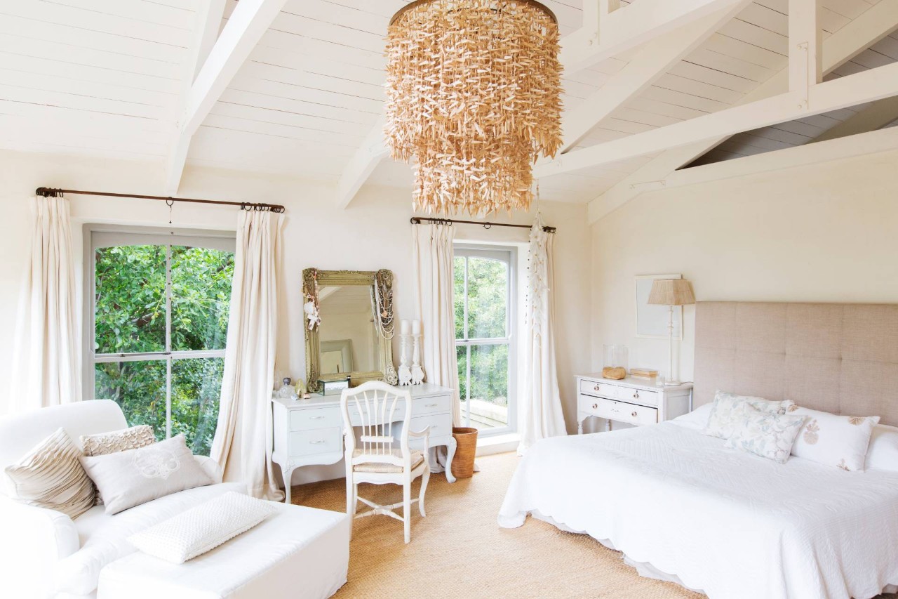 A modern farmhouse bedroom with fabric window treatments and a neutral theme with antique-inspired tables at All About Blinds JC near johnson city, Tennessee (TN)