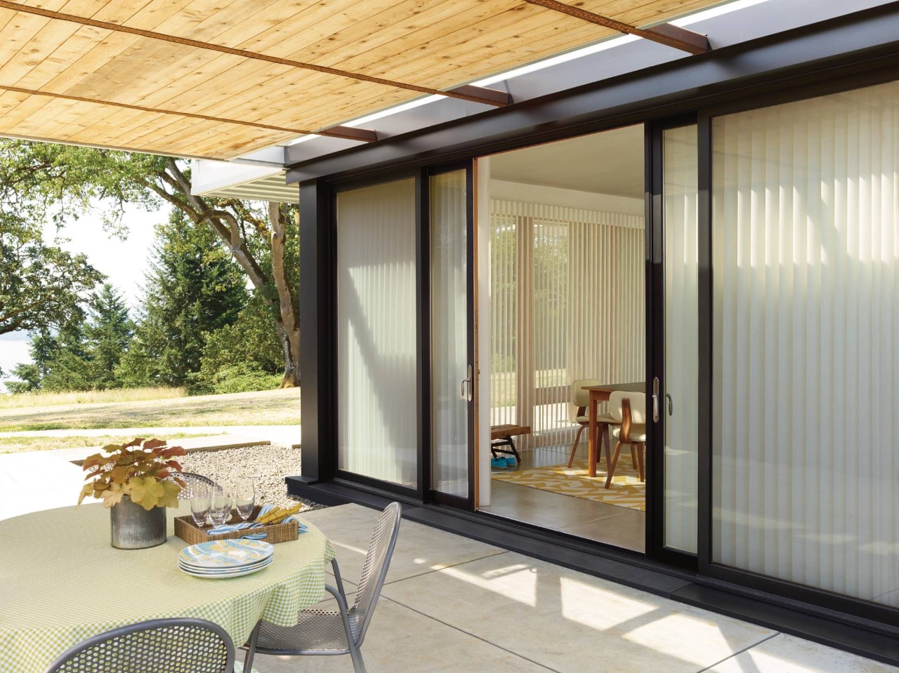 Outside view of Hunter Douglas Luminette® Sheer Panels on a black contemporary-style patio door at All About Blinds near Johnson City, TN
