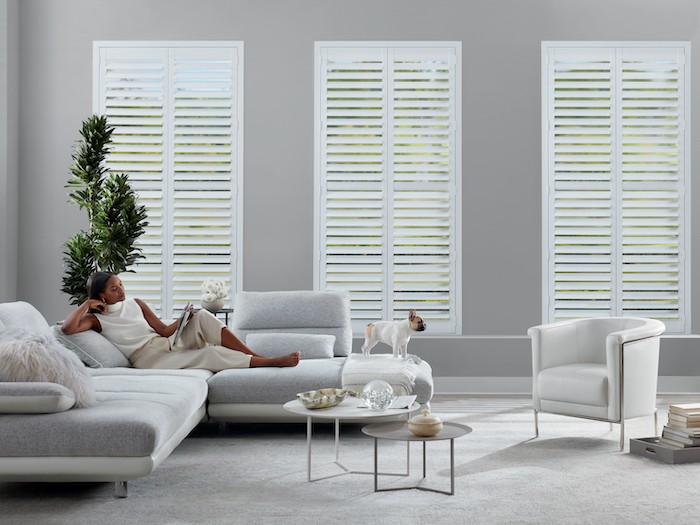 A living room with white furniture.