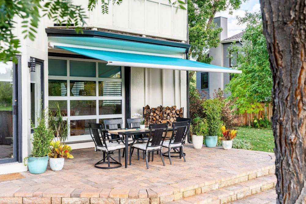 Sol-Lux Freedom Awning hanging over an outdoor table and chairs at All About Blinds near Johnson City, Tennessee (TN)